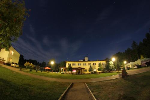 a large white building on a street at night at OW Mikomania in Charzykowy