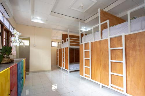 a room with several bunk beds in a room at Nushe Hostel & Room in Nusa Penida