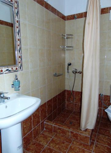 a bathroom with a sink and a shower at Lefteris Houses in Karterados