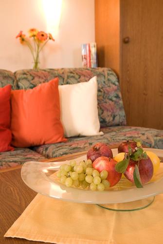 a plate of fruit on a table with a couch at Haus Bergheimat in Abtenau
