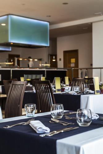 a dining room with tables and chairs with wine glasses at Royal Palm Resort & Spa - Adults Only in Playa Jandia