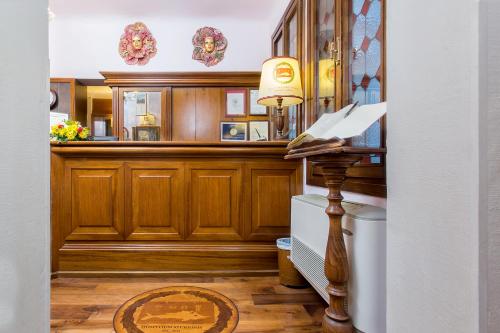 a hallway with wood paneling and a table with a lamp at Antica Locanda Sturion Residenza d'Epoca in Venice