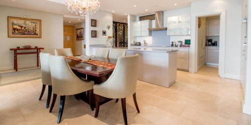 a kitchen and dining room with a table and chairs at Waterfront Village in Cape Town