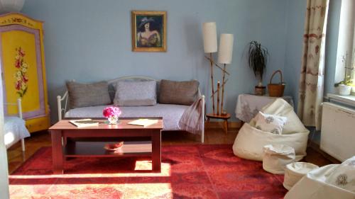 a living room with a couch and a coffee table at Studniska Horse Centrum in Studniska