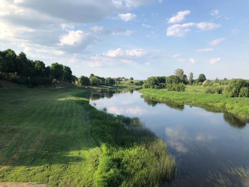 an aerial view of a river in a field at Skrunda Apartments Elandrum in Skrunda