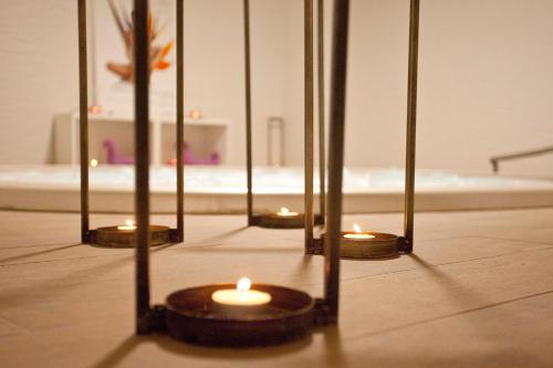 a group of candles in front of a mirror at Hotel Pompaelo Plaza del Ayuntamiento & Spa in Pamplona
