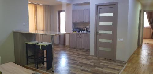 a kitchen with a counter and a bar in a room at Cross Resort Hotel in Yerevan