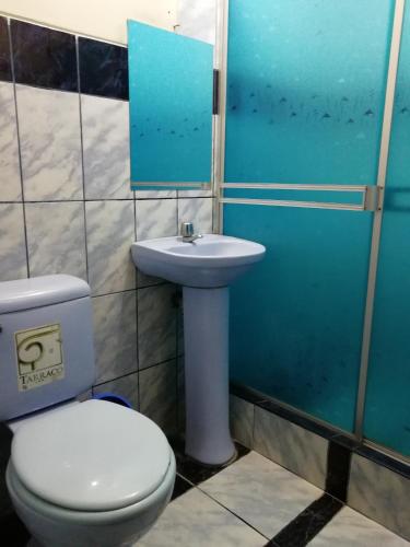 a bathroom with a toilet and a sink at Hotel Nuevo Amanecer Malabrigo in Puerto Chicama