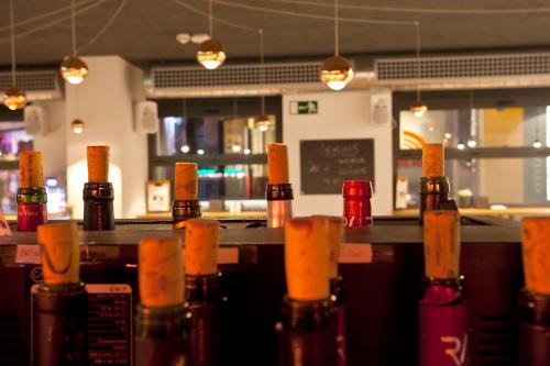 a row of wine bottles lined up on a bar at Hotel Pompaelo Plaza del Ayuntamiento & Spa in Pamplona