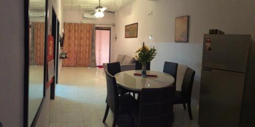 a dining room with a table and a refrigerator at Ipoh homestay in Ipoh