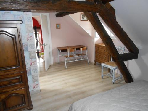 a attic room with a bed and a desk at gite du vivier 2km du parc beauval in Seigy