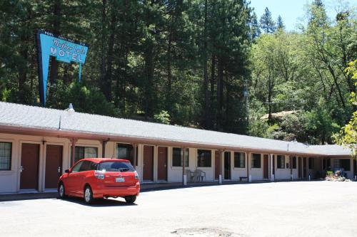 a red car parked in front of a motel at Mother Lode Motel in Placerville