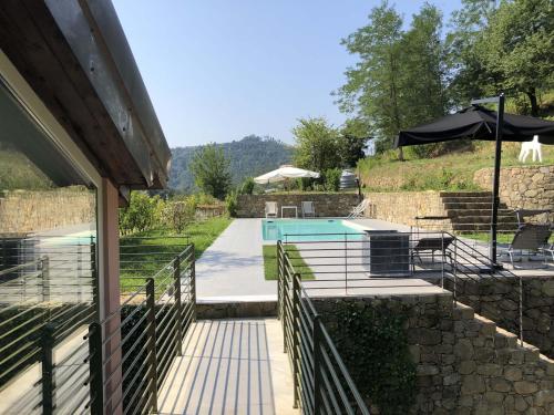 a house with a swimming pool and a patio at VILLA DELLE ROSE CINQUE TERRE in Beverino