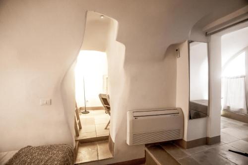 a small room with a staircase and a mirror at Dimore del TEMPO PERS0 Terrae Globus in Ostuni
