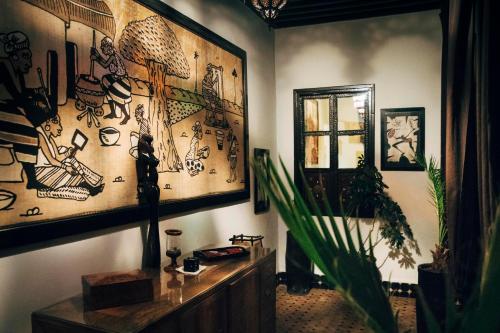 a living room with art on the walls at Dar Najat in Marrakech