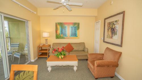 a living room with a couch and a table at Barefoot Suite in Orlando