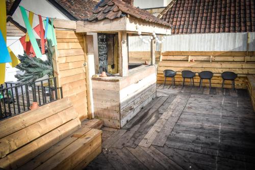 an outdoor deck with chairs and a building at The Dark Horse Pub in Bristol