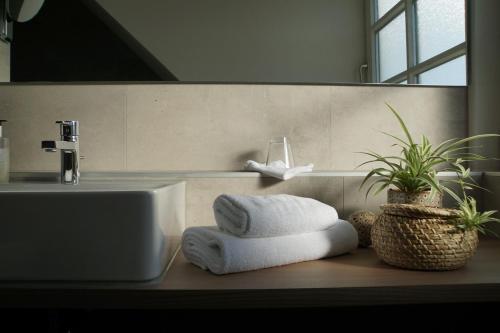 a bathroom with towels on a counter next to a sink at Adler Botenheim in Botenheim