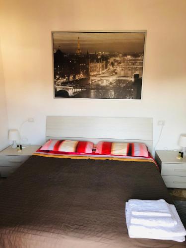 a bedroom with a bed with a picture on the wall at Ca’Melia B&B in Arconate