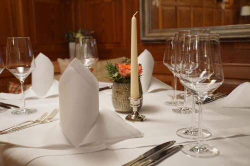 a table with white napkins and wine glasses on it at Adler Botenheim in Botenheim