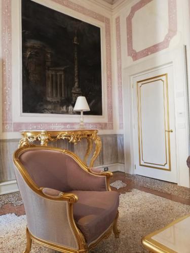a room with a chair and a picture of the eiffel tower at Ca' Bonfadini Historic Experience in Venice