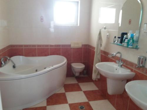 a bathroom with a tub and a toilet and a sink at Hradna 9a in Nové Zámky