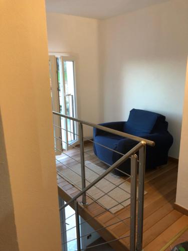 a stair case with a blue couch in a room at La Finestra sul mare in La Spezia