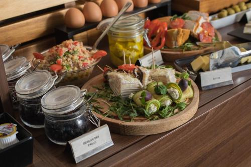 a buffet with plates of food on a table at Best Western Premier Natalija Residence in Belgrade