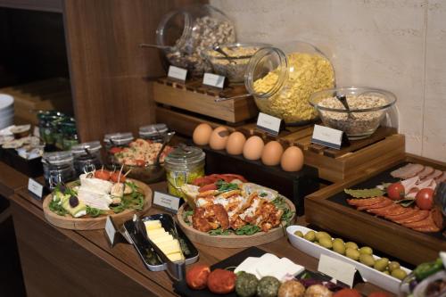 a buffet with many different types of food in baskets at Best Western Premier Natalija Residence in Belgrade