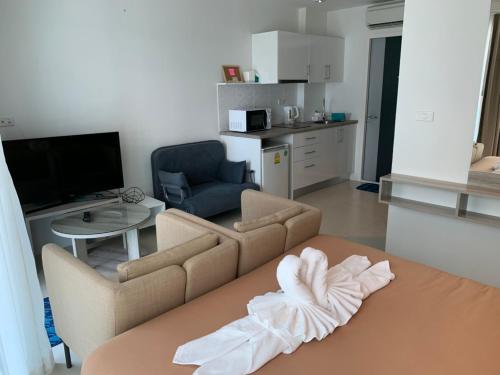 a living room with a couch and a table at Grand Blue Condominium by Mary in Mae Pim