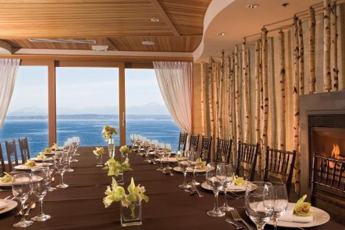 a long table in a room with a view of the ocean at The Edgewater, a Noble House Hotel in Seattle