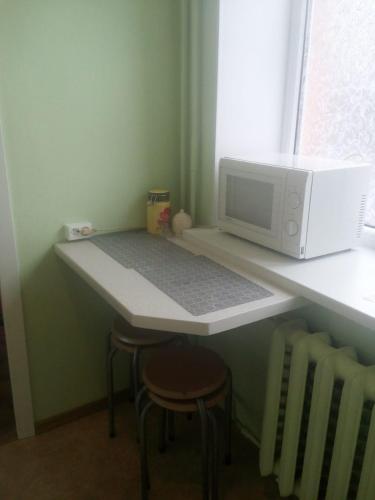 a microwave sitting on a counter next to a table at Viestura apartamenti in Daugavpils