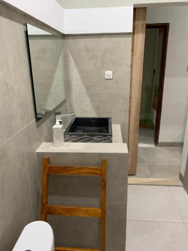 a bathroom with a counter with a sink and a mirror at Dalai Home in Kuta Lombok