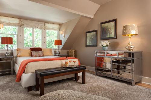 a bedroom with a bed and a table at Gothic Eves Inn and Spa Bed and Breakfast in Trumansburg