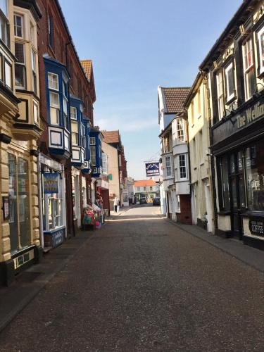 an empty street in a town with buildings at The Upper Bakery in Cromer