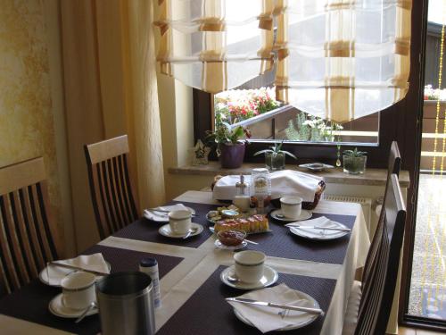 a dining room table with a black and white table cloth at Gästehaus Stroitz in Drobollach am Faakersee