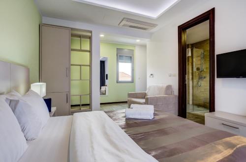 a bedroom with a bed and a living room at Riva Residence in Herceg-Novi