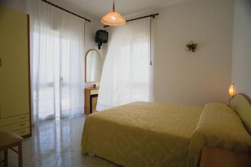 a bedroom with a bed and a dresser and a mirror at Villa Natalina in Ischia