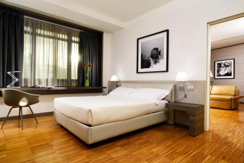 Katil atau katil-katil dalam bilik di UNA Hotels San Vitale Bologna