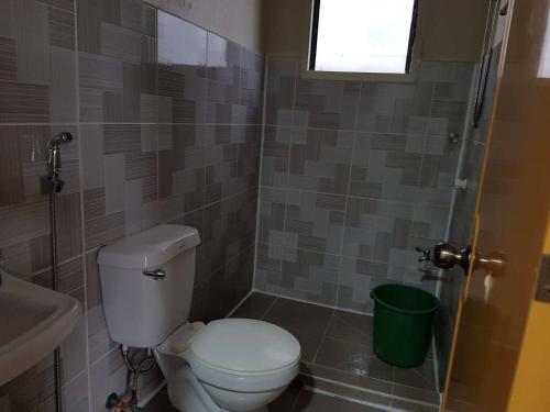 a bathroom with a toilet and a sink at Madid's Inn Beach Resort in Boracay