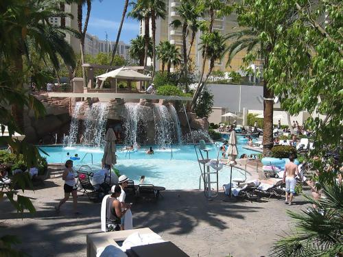 a swimming pool with a waterfall in a resort at MGM Signature in Las Vegas