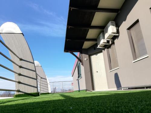 an external view of a building with green grass at Motel Kratos in Bisignano