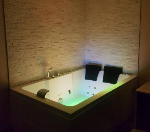 a bath tub in a room with a brick wall at Motel Kratos in Bisignano