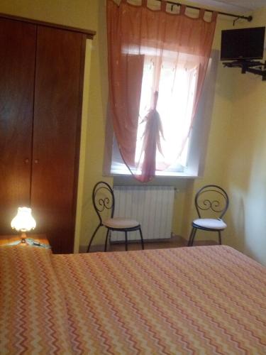 Ένα ή περισσότερα κρεβάτια σε δωμάτιο στο Hotel Il Malandrone