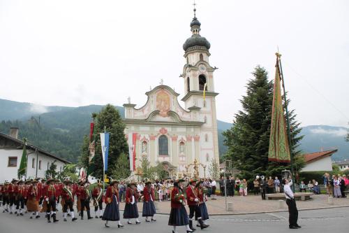 a marching band in front of a church at Alp Art Hotel Götzens in Innsbruck