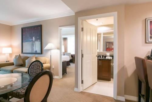 a living room with a couch and a dining room at MGM Signature in Las Vegas