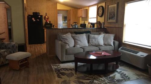 a living room with a couch and a table at The Sandstone - A 3BR, 2BA Deluxe Log Cabin in Genoa