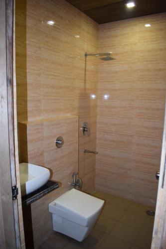 a bathroom with a toilet and a shower with a sink at Hotel Star Light in Amritsar