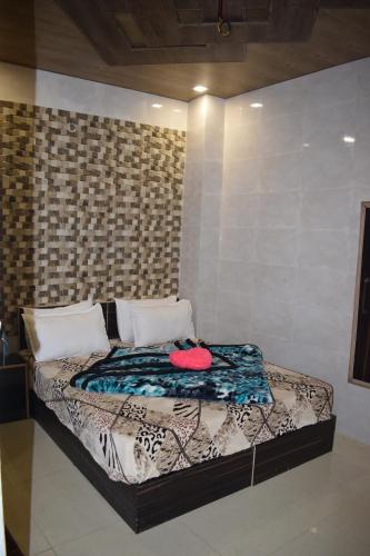a bed in a room with a wall at Hotel Star Light in Amritsar