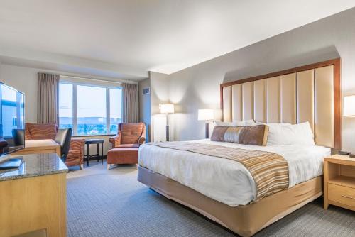 a hotel room with a large bed and a television at Westmark Fairbanks Hotel and Conference Center in Fairbanks